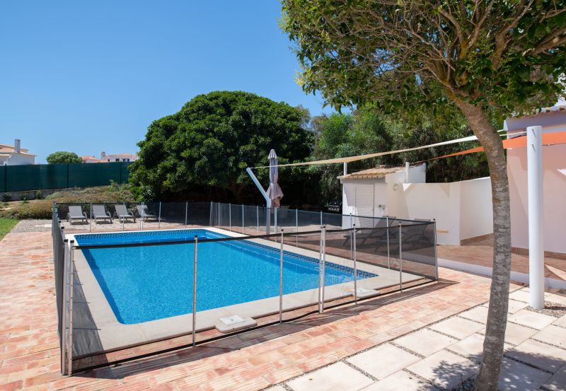 Child Playing Near Mesh Fence